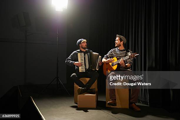 musicians playing on small stage under spotlight. - accordion instrument stockfoto's en -beelden