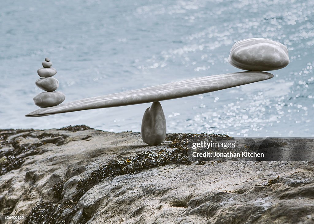 Zen-like stone scales on a stone next to sea