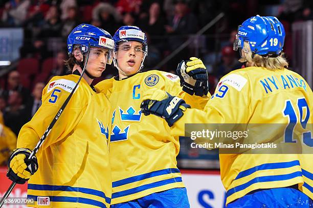 Alexander Nylander of Team Sweden celebrates with teammates David Bernhardt and Joel Eriksson Ek of Team Sweden during the IIHF World Junior...