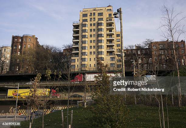 View across an earthen berm overlooks residential townhouses and apartment buildings along the Brooklyn Queens Expressway in Brooklyn Heights...