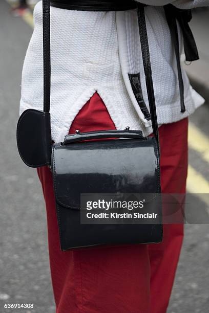 Illustrator Isabella Hemmersbach wears vintage jujitsu jacket, vintage trousers and Marques Almeida bag on day 2 of London Womens Fashion Week...