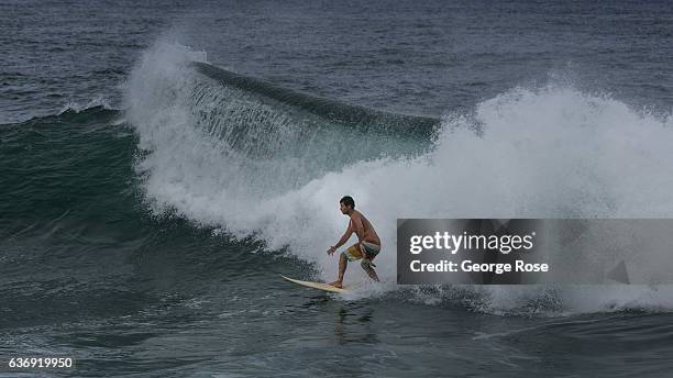 Surfer rides a ten foot wave breaking along the shore at Keokeo Beach Park on December 17 near Kapaau on the Kohala Coast, Hawaii. Hawaii, the...