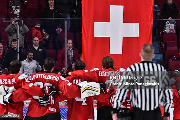 Team Switzerland looks on as the flag of Switzerland is raised during the IIHF World Junior Championship preliminary round game against Team Czech...