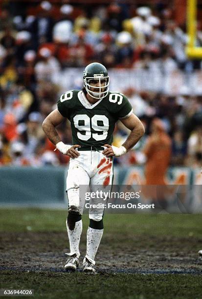 Defensive end Mark Gastineau of the New York Jets looks on against the Miami Dolphins during an NFL football game circa 1982 at the Orange Bowl in...