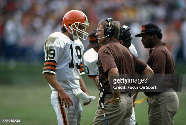 Head Coach Marty Schottenheimer of the Cleveland Browns talks with his quarterback Bernie Kosar during an NFL football game circa 1987 at Cleveland...