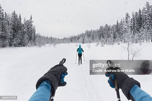 couple cross country skiing on a winter trail - black glove stock pictures, royalty-free photos & images