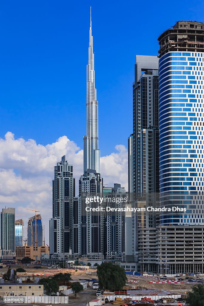 Dubai, UAE: Skyline Under Construction against Blue Sky