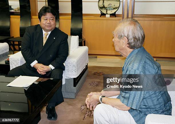 Japan - Tsuyoshi Gibu , mayor of Kin Town in Okinawa Prefecture, southwestern Japan, tells Okinawa Governor Hirokazu Nakaima of the town office's...