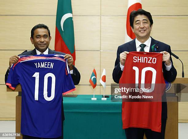 Japan - Japanese Prime Minster Shinzo Abe and Maldives President Abdulla Yameen smile after exchanging shirts of the two countries' national football...