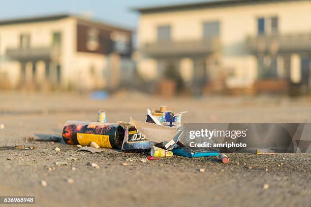 firework leftovers with european houses - firework explosive material stock pictures, royalty-free photos & images