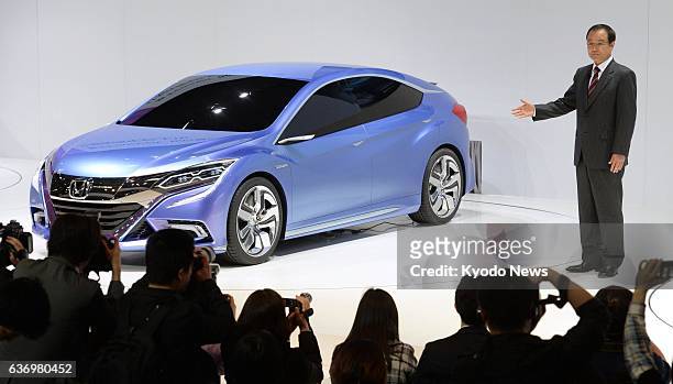 China - Honda Motor Co. President Takanobu Ito takes the wraps off a prototype hatchback model the Japanese maker has developed for the Chinese...