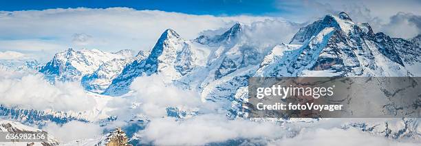 snowy alpine peaks eiger overlooking cable car station alps switzerland - lauterbrunnen stock pictures, royalty-free photos & images