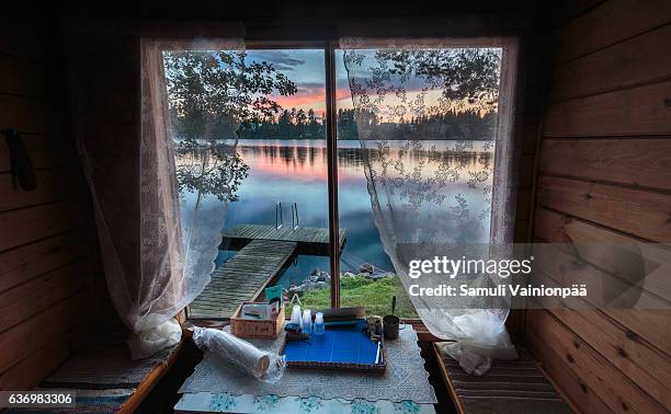 lake seen from a traditional sauna window - sauna stock-fotos und bilder