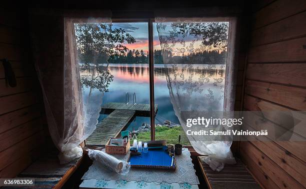 lake seen from a traditional sauna window - finland ストックフォトと画像