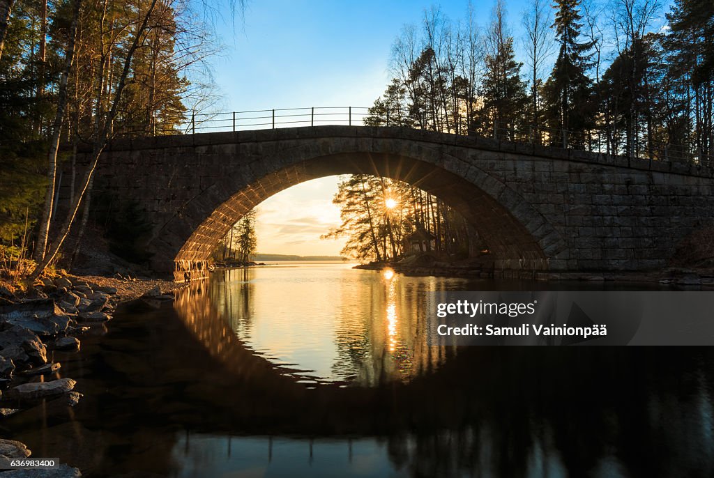 An arch bridge at sunset