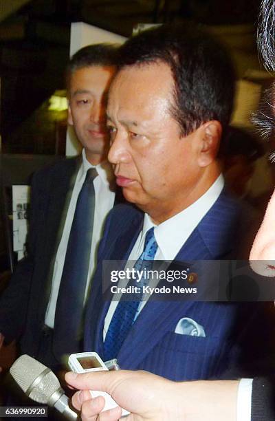 Japan - Akira Amari, Japan's minister in charge of the Trans-Pacific Partnership negotiations, leaves the Cabinet Office in Tokyo around 3 a.m. On...