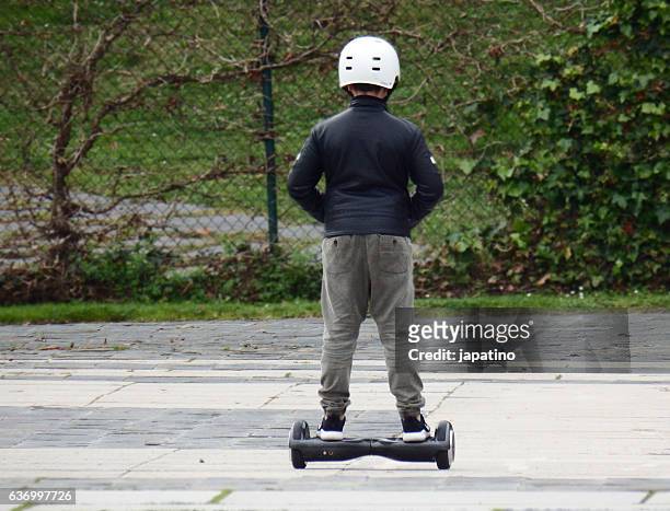 child having fun with an two-wheel electric skate - hover board ストックフォトと画像