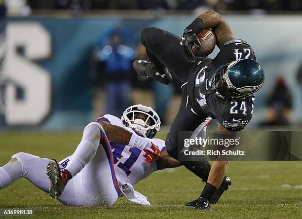 Running back Ryan Mathews of the Philadelphia Eagles is tackled by corner back Dominique Rodgers-Cromartie of the New York Giants in the fourth...