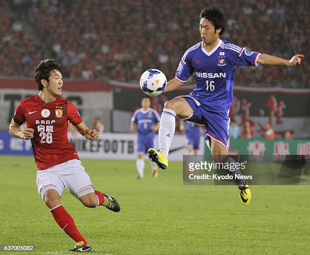 China - Sho Ito of Yokohama F Marinos controls the ball in front of Guangzhou Evergrande's Kim Young Gwon in the first half of a Group G match in the...