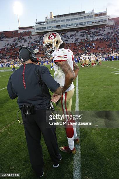 Head Coach Chip Kelly and Colin Kaepernick of the San Francisco 49ers alk on the field during the game against the Los Angeles Rams at the Los...