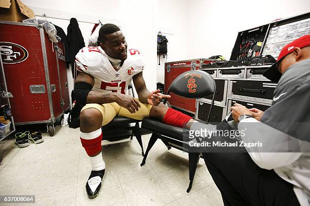 Gerald Hodges of the San Francisco 49ers gets tapped up in the locker room prior to the game against the Los Angeles Rams at the Los Angeles Coliseum...