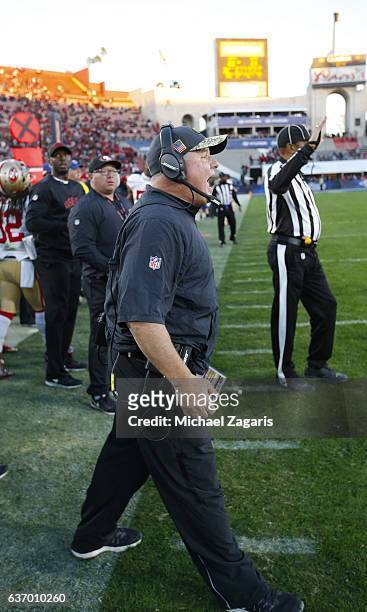 Head Coach Chip Kelly of the San Francisco 49ers sands on the sideline during the game against the Los Angeles Rams at the Los Angeles Coliseum on...