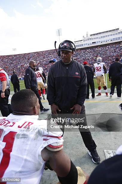Inside Linebackers Coach Joe Bowden of the San Francisco 49ers talks with Gerald Hodges on the sideline during the game against the Los Angeles Rams...