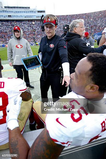 Outside Linebackers Coach Jason Tarver of the San Francisco 49ers talks with Ahmad Brooks on the sideline during the game against the Los Angeles...