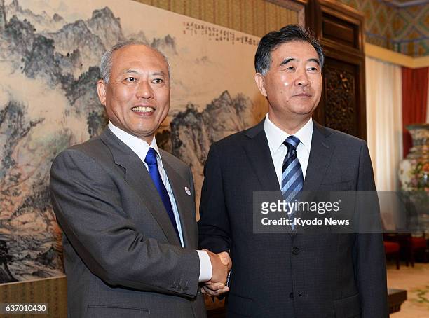 China - Visiting Tokyo Gov. Yoichi Masuzoe and Chinese Vice Premier Wang Yang shake hands in Beijing on April 26 prior to their talks. After the...