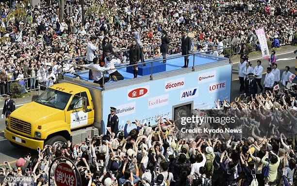 Japan - People gather to see Sochi Olympic figure skating gold medalist Yuzuru Hanyu during a parade in his hometown Sendai, Miyagai Prefecture, on...