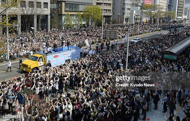 Japan - People gather to see Sochi Olympic figure skating gold medalist Yuzuru Hanyu during a parade in his hometown Sendai, Miyagai Prefecture, on...