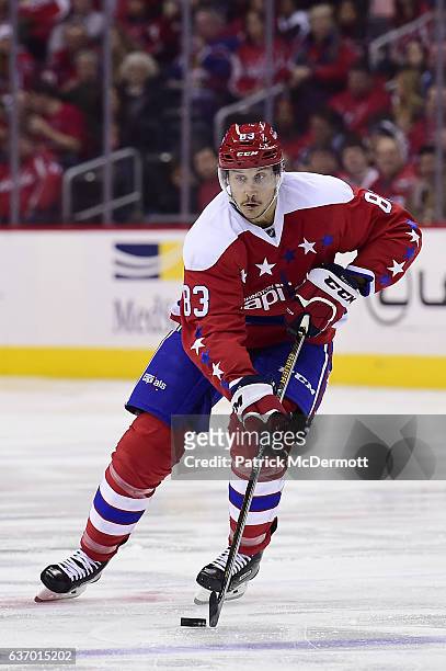 Jay Beagle of the Washington Capitals controls the puck against Tampa Bay Lightning in the third period during a NHL game at Verizon Center on...