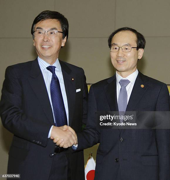 South Korea - Japanese Environment Minister Nobuteru Ishihara and South Korean Environment Minister Yoon Seong Kyu shake hands in Daegu, South Korea,...