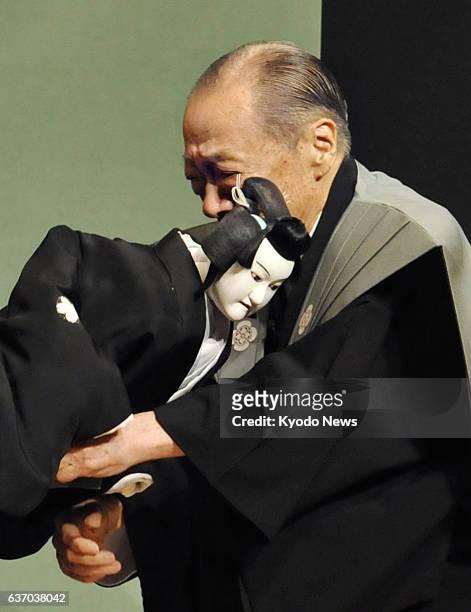 Japan - Master "Joruri" narrative music chanter Takemoto Sumidayu hugs a puppet in tears after the 89-year-old performer's final stage appearance...