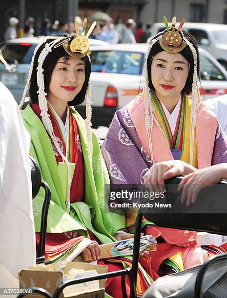 Japan - Women wear "junihitoe" , a type of court attire, as participants in a parade held in Kyoto, western Japan, on April 27 to commemorate the...