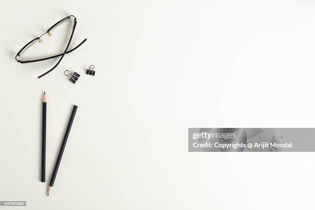Directly Above Shot Of Eye Glass, Pencils With Blank Copy Space On White Background