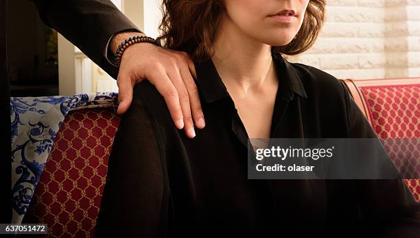 troubled harrassed woman dislikes his hand. she wears ring. - colleague engagement stock pictures, royalty-free photos & images