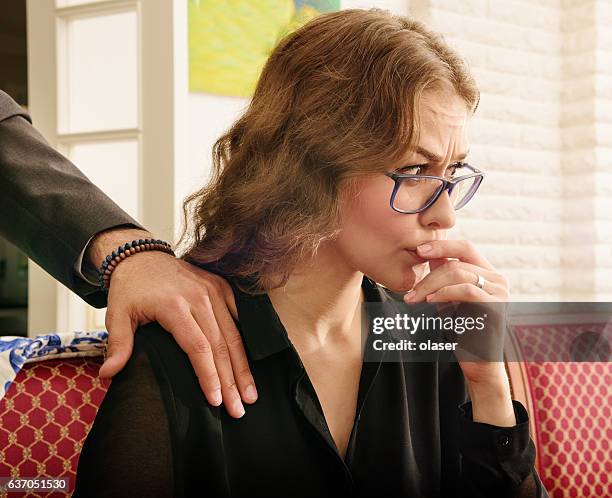 troubled harrassed woman dislikes his hand. she wears ring. - colleague engagement stock pictures, royalty-free photos & images