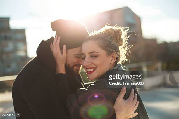 happy young couple outdoors - happy couple cuddle stockfoto's en -beelden