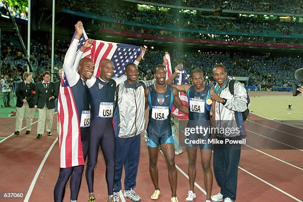 Michael Johnson of the USA poses with his teammates after winning the Gold Medal in the Mens 4x400m Final Event during the 2000 Sydney Olympic Games...