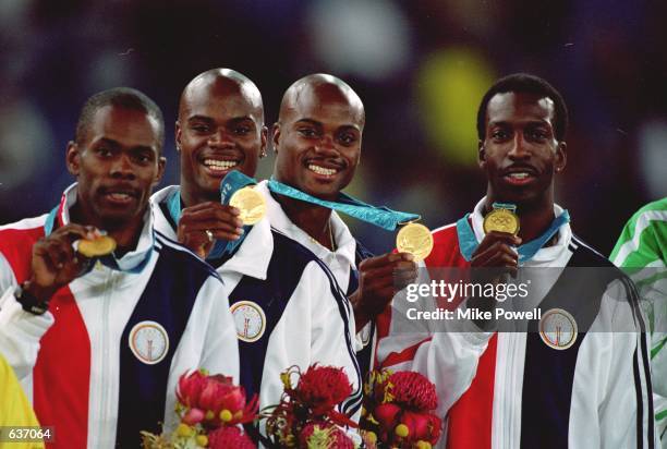 Michael Johnson, Antonio Pettigrew, Alvin And Calvin Harrison of the USA pose with their Medals after winning the Gold Medal in the Mens 4x400m Final...