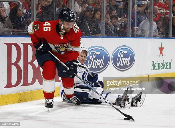 Jakub Kindl of the Florida Panthers skates away with the puck after Zach Hyman of the Toronto Maple Leafs goes to the ice at the BB&T Center on...