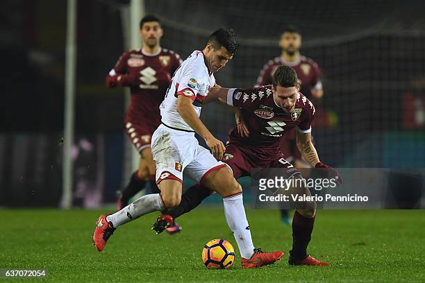 Andrea Belotti of FC Torino is challenged by Ezequiel Munoz of Genoa CFC during the Serie A match between FC Torino and Genoa CFC at Stadio Olimpico...