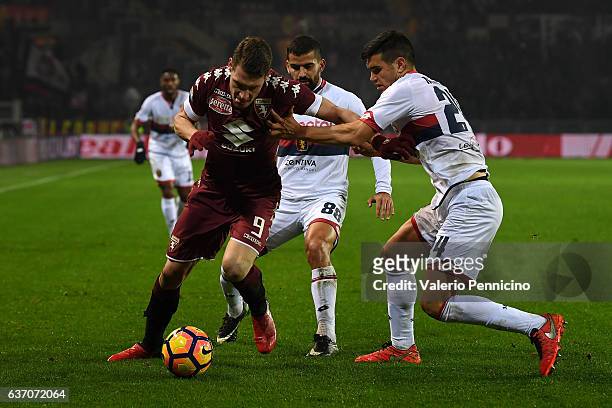 Andrea Belotti of FC Torino is challenged by Ezequiel Munoz of Genoa CFC during the Serie A match between FC Torino and Genoa CFC at Stadio Olimpico...