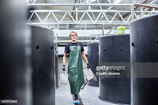 man working in fish farm - aquaculture stock pictures, royalty-free photos & images