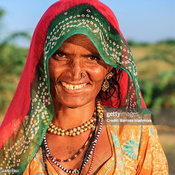 happy indian old woman in desert village, india - gypsy stock pictures, royalty-free photos & images