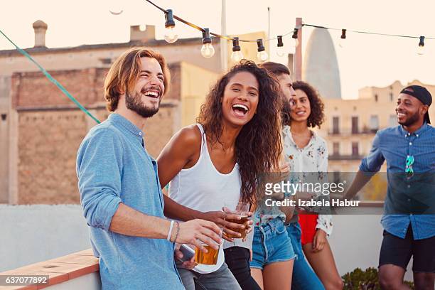 happy friends at the rooftop party - rooftop party stock pictures, royalty-free photos & images