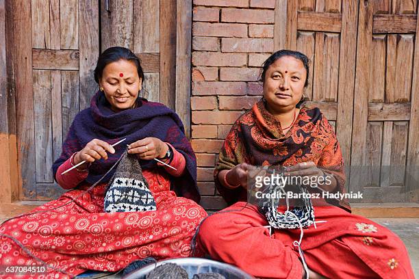 nepali women  kniting wool hat. bhaktapur. - durbar square stock pictures, royalty-free photos & images