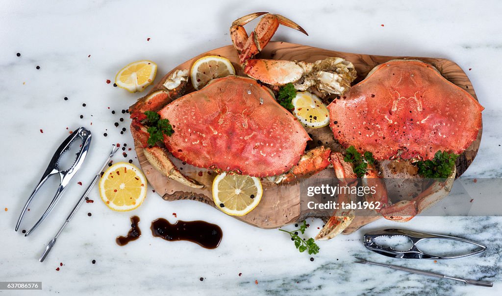 Freshly cooked crab with spices on wooden server