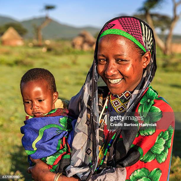 woman from borana tribe holding her baby, ethiopia, africa - borana stock pictures, royalty-free photos & images